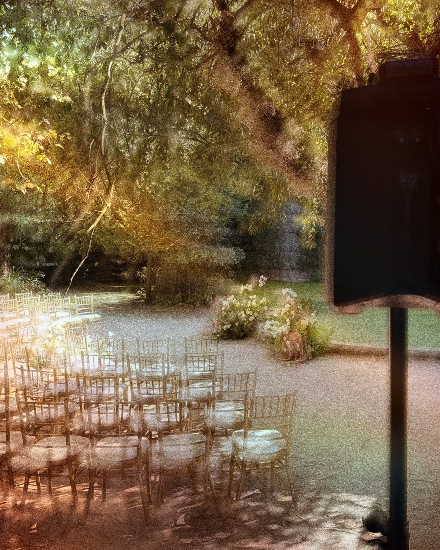 Garden ceremony set up with chairs and a speaker